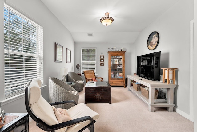 living room featuring lofted ceiling and light colored carpet