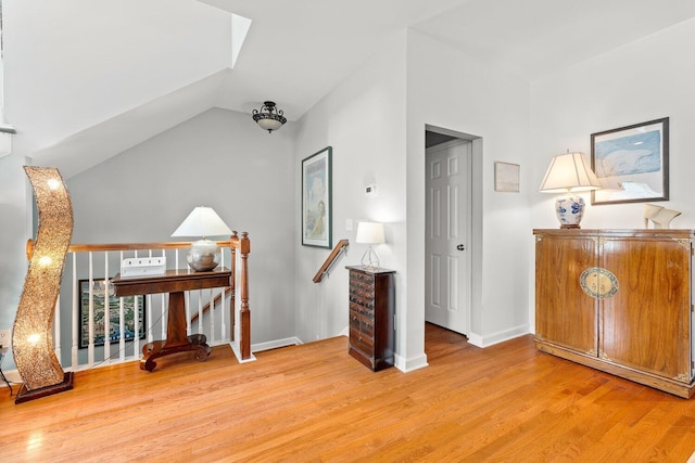 sitting room with lofted ceiling and hardwood / wood-style flooring