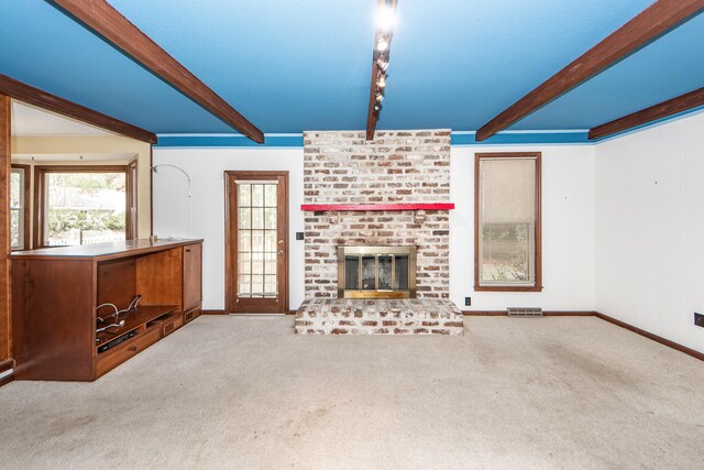 unfurnished living room featuring light carpet, a brick fireplace, and beam ceiling