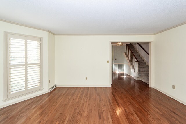 unfurnished room with dark hardwood / wood-style flooring, a textured ceiling, and ornamental molding