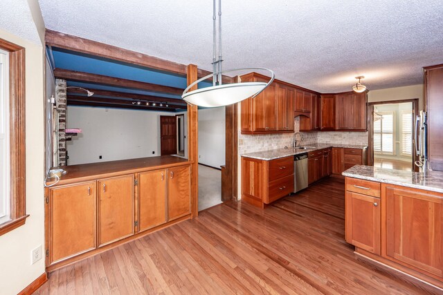 kitchen with dishwasher, light hardwood / wood-style flooring, decorative light fixtures, and backsplash