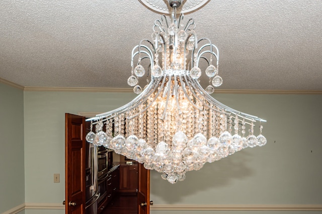 interior details featuring oven, a textured ceiling, and crown molding