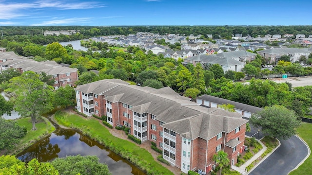 drone / aerial view featuring a residential view and a water view