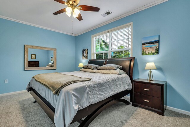 bedroom featuring crown molding, ceiling fan, and light carpet