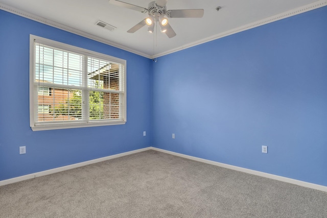 spare room with visible vents, ornamental molding, a ceiling fan, carpet, and baseboards