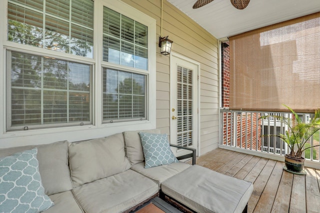 deck with an outdoor hangout area and a ceiling fan