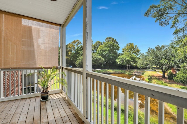 wooden terrace featuring a water view