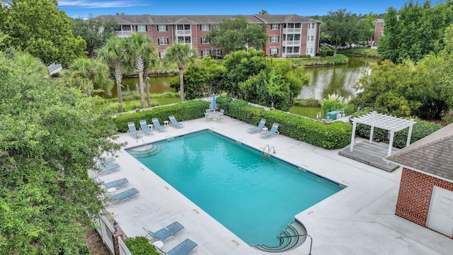 pool with a water view, a patio, and a pergola