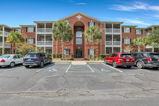 view of front of property with a balcony and cooling unit