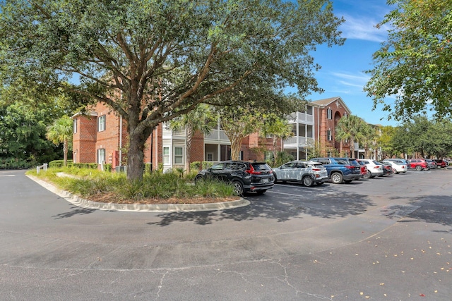 view of building exterior with uncovered parking