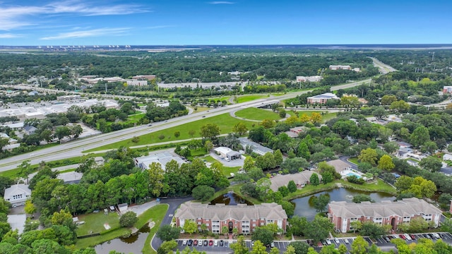 drone / aerial view featuring a residential view and a water view