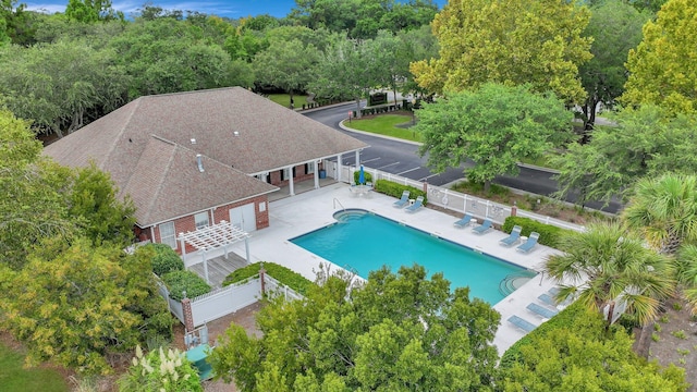 pool with a patio and a fenced backyard