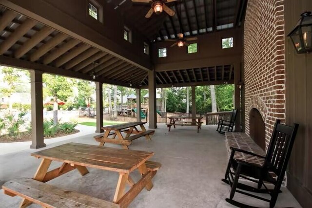 view of patio / terrace with an outdoor brick fireplace and ceiling fan