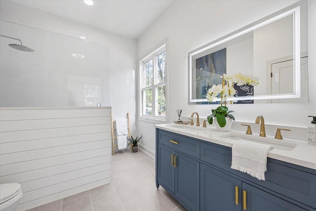 bathroom with vanity, toilet, tile patterned flooring, and a shower