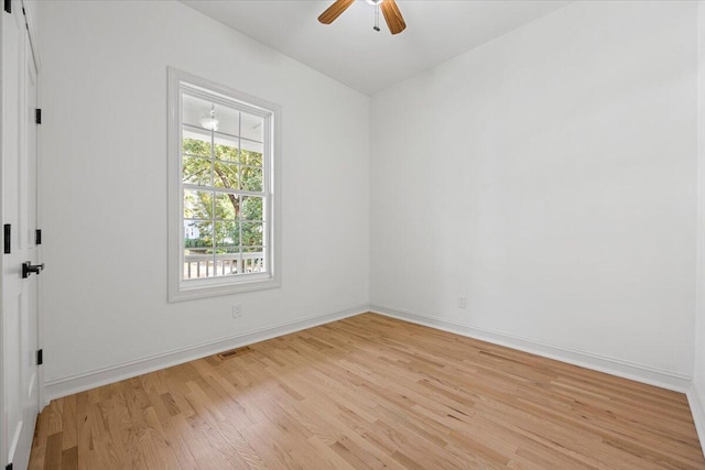 empty room with ceiling fan and light hardwood / wood-style floors