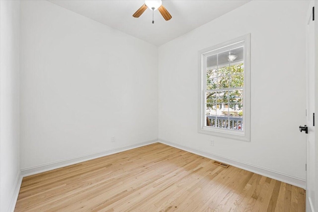 empty room with ceiling fan and light hardwood / wood-style flooring