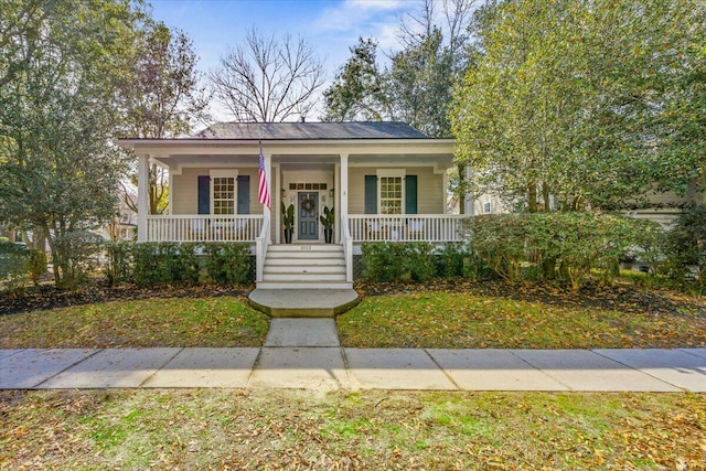 view of front of house featuring a front yard and a porch