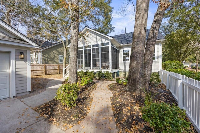 back of property with a sunroom