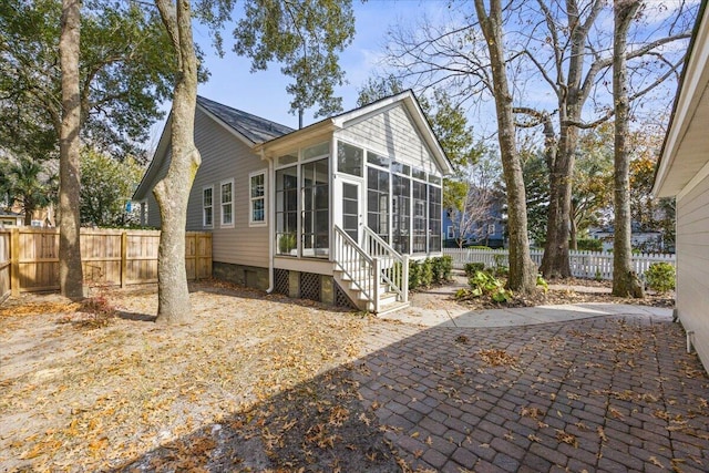 exterior space featuring a patio area and a sunroom