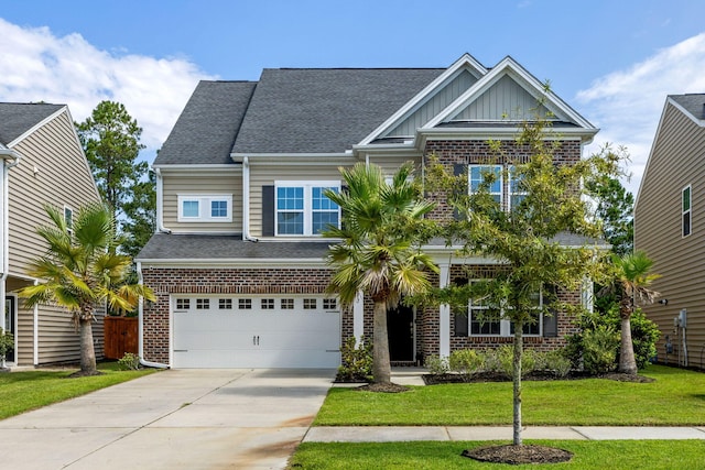 craftsman house featuring a garage and a front lawn