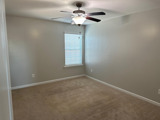 carpeted empty room featuring ceiling fan