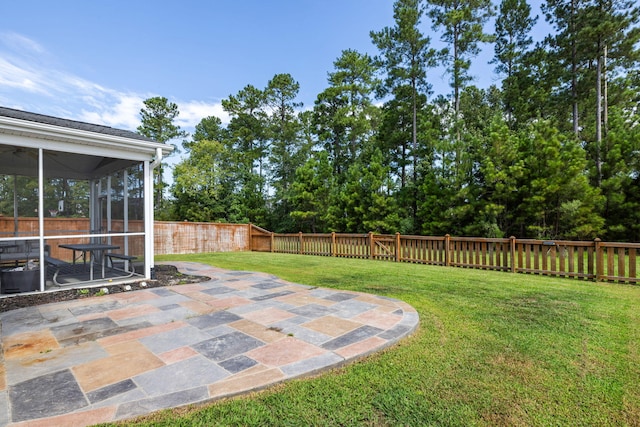 view of yard featuring a sunroom and a patio area