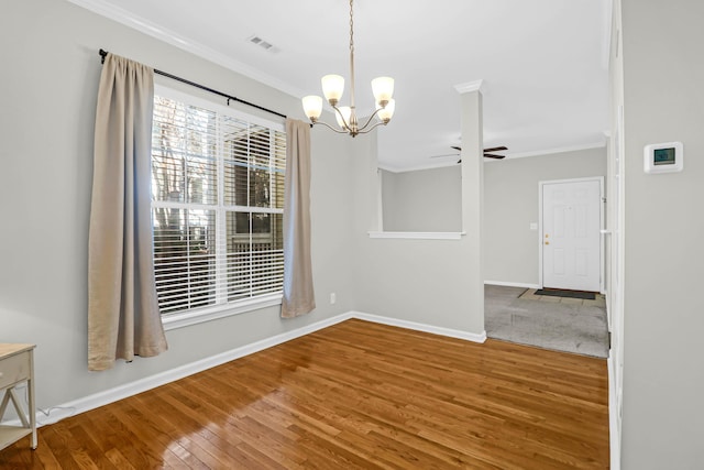 unfurnished dining area with ceiling fan with notable chandelier, ornamental molding, and hardwood / wood-style floors