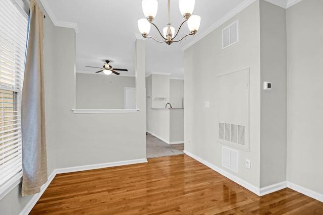 interior space featuring hardwood / wood-style flooring, crown molding, and a chandelier