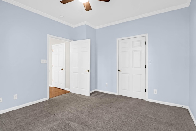 unfurnished bedroom featuring ceiling fan, dark carpet, and ornamental molding