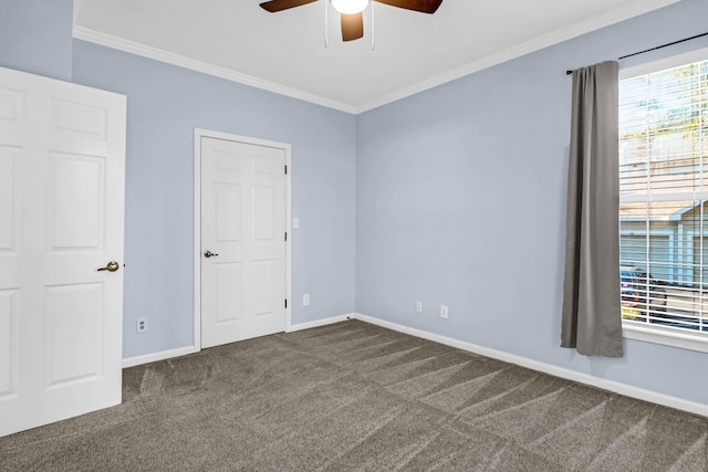 carpeted empty room featuring ceiling fan and ornamental molding