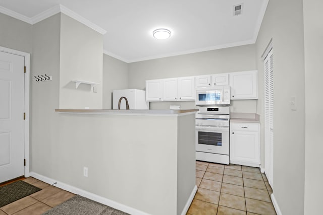 kitchen with light tile patterned floors, white cabinetry, and white appliances