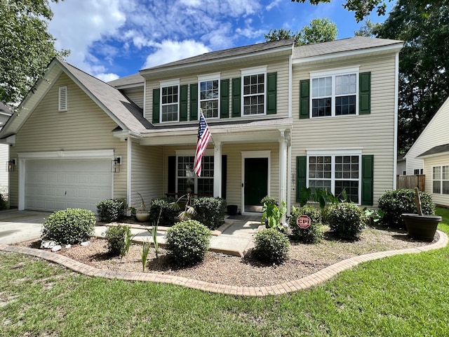 view of front of property with a front yard and a garage