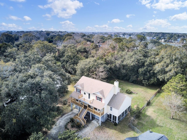 birds eye view of property with a view of trees