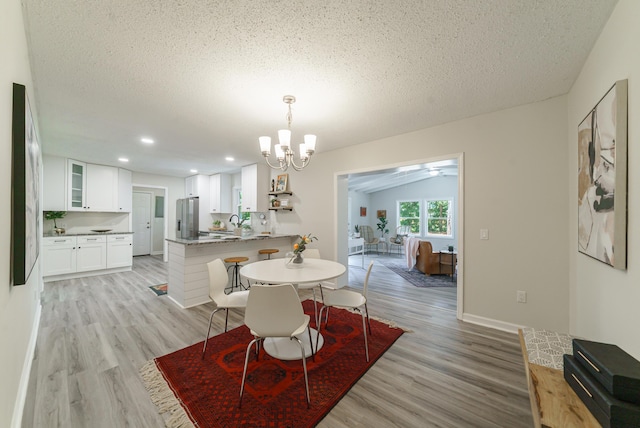 106 Kent Cir, Ladson, SC 29456 - dining area with a textured ceiling, a chandelier, baseboards, and light wood finished floors