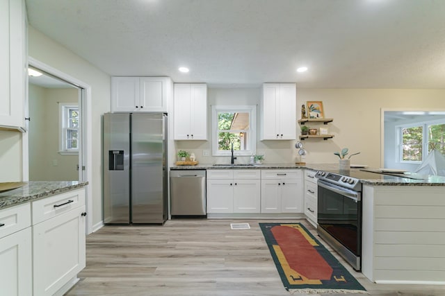 106 Kent Cir, Ladson, SC 29456 - kitchen featuring light stone counters, stainless steel appliances, white cabinetry, a peninsula, and a healthy amount of sunlight