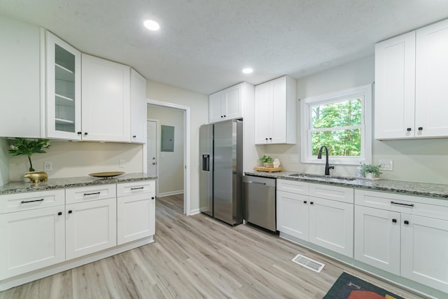 106 Kent Cir, Ladson, SC 29456 - kitchen featuring visible vents, light wood-style flooring, a sink, stainless steel appliances, and white cabinetry