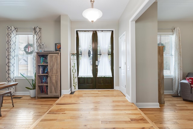 entryway with hardwood / wood-style flooring and french doors