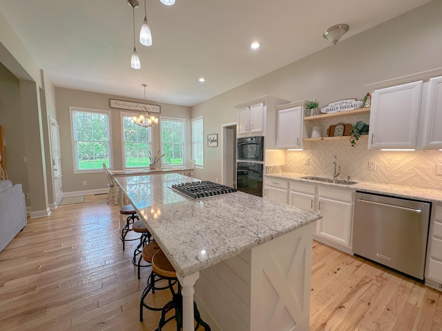 1129 Plantation Overlook Dr, Moncks Corner, SC 29461 - kitchen with stainless steel appliances, open shelves, a chandelier, white cabinetry, and decorative backsplash