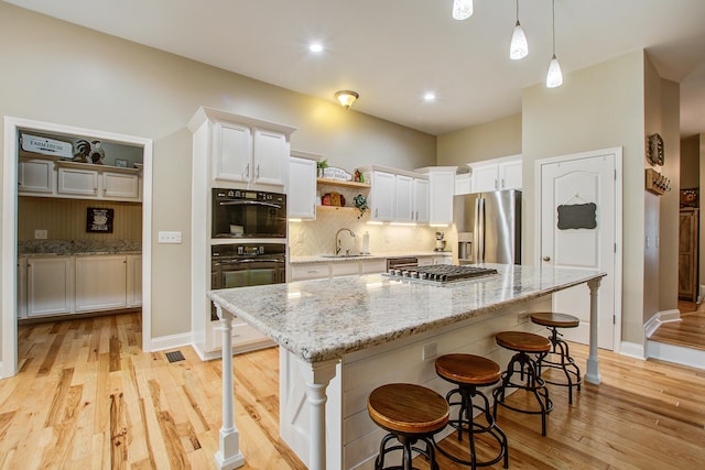1129 Plantation Overlook Dr, Moncks Corner, SC 29461 - kitchen featuring appliances with stainless steel finishes, open shelves, white cabinetry, tasteful backsplash, and recessed lighting
