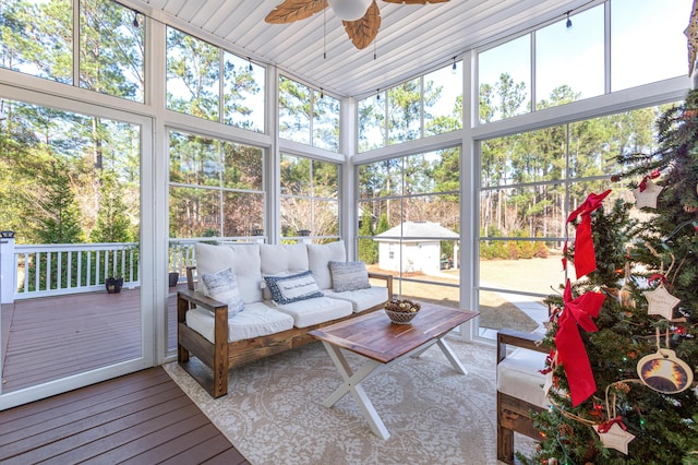 sunroom / solarium featuring ceiling fan