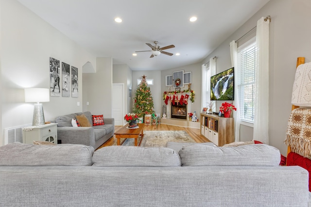 living room with ceiling fan and light hardwood / wood-style flooring