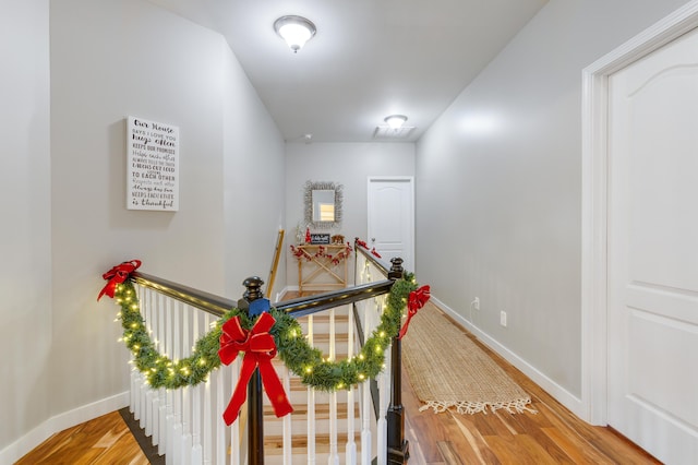 hall with hardwood / wood-style flooring