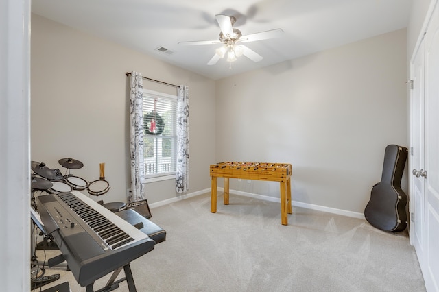 interior space featuring light colored carpet and ceiling fan