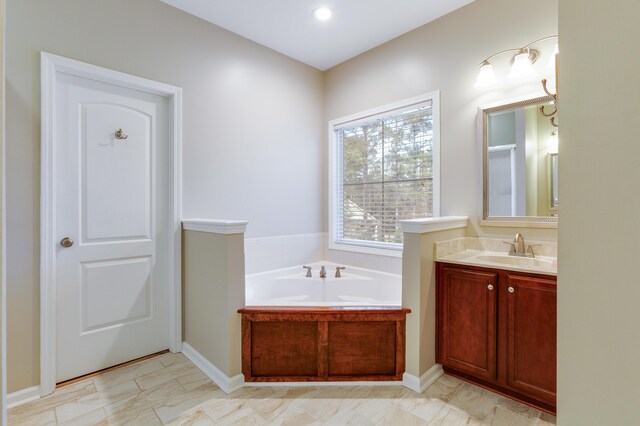 bathroom featuring vanity and a bath