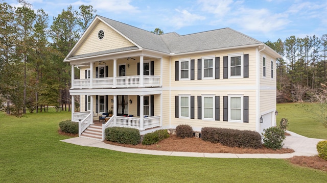 view of front of home featuring a balcony, a garage, covered porch, and a front yard