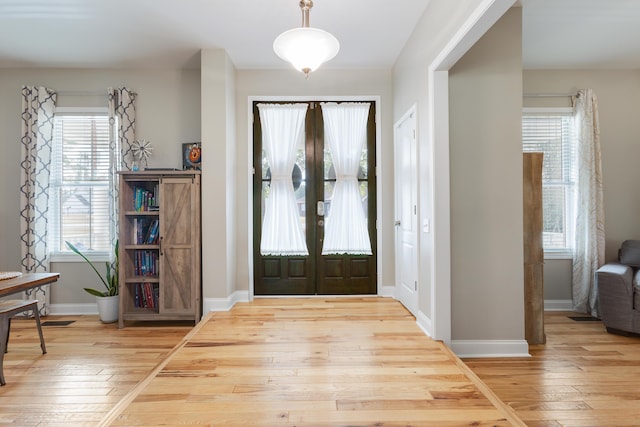 foyer entrance featuring wood-type flooring and french doors