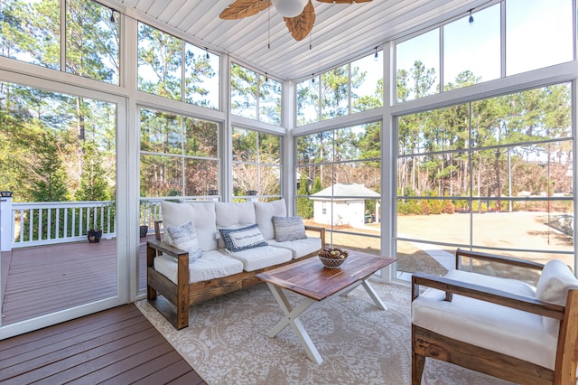 sunroom featuring ceiling fan and plenty of natural light