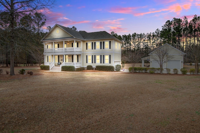 view of front of home with a porch, a balcony, and a yard