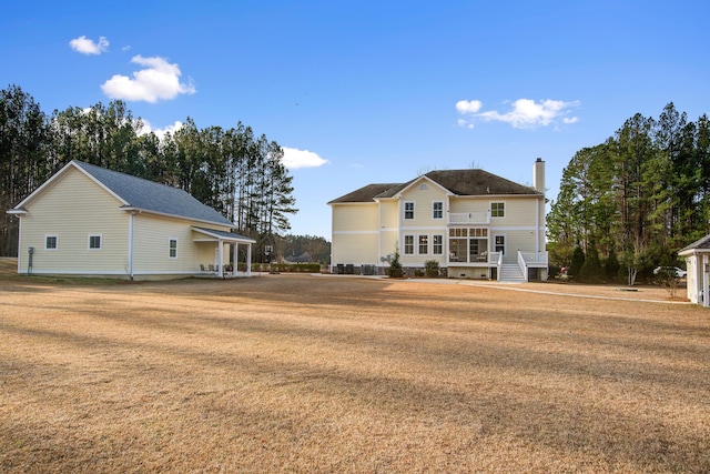 back of property with a lawn