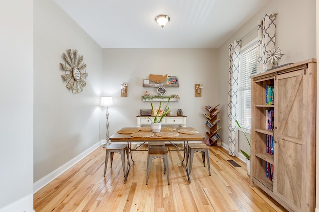 dining area with hardwood / wood-style flooring